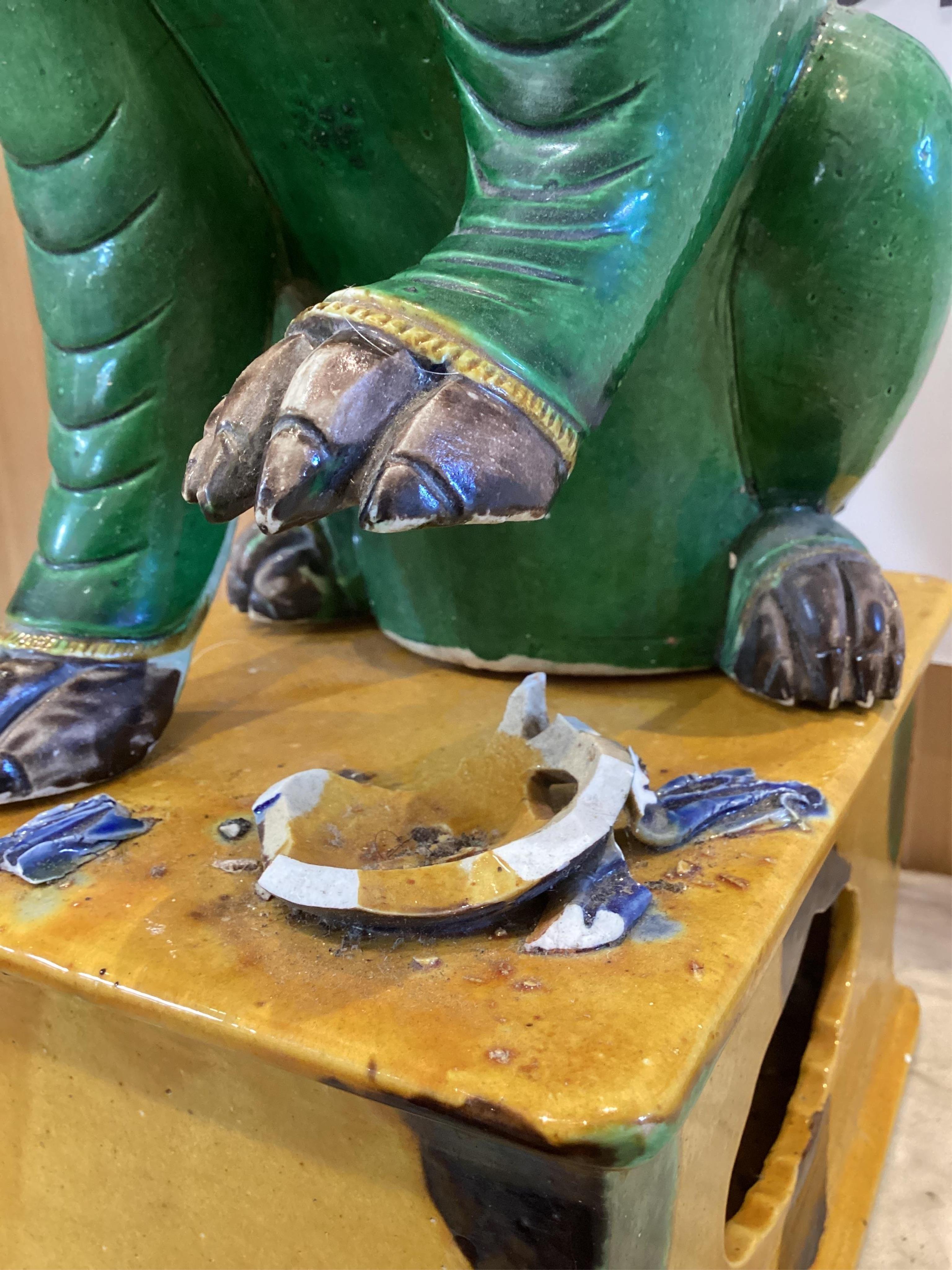 A pair of large Chinese sancai-glazed biscuit figures of Buddhist temple lions, 19th century